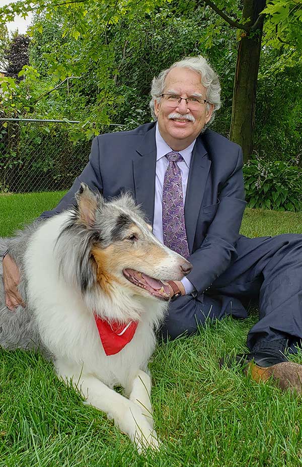 Photo of Mark E. Sostarich with his dog.